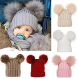 Collection of baby hats with pom-poms in various colors 