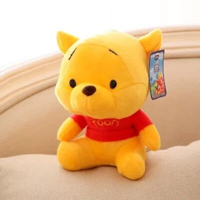 Plush toy resembling a bear in a red shirt with a tag