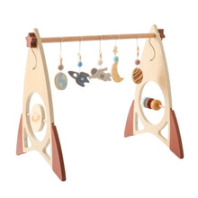 Wooden baby gym with hanging toys.