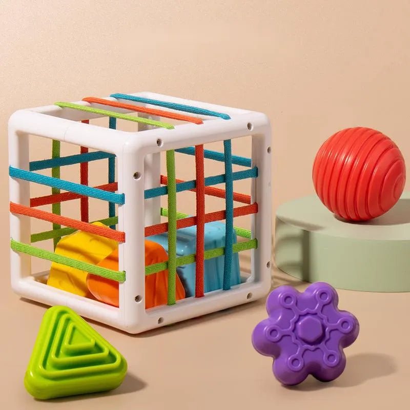 Colorful toy cube with various shapes.