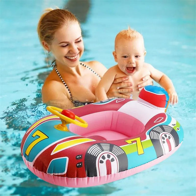 Woman holding a baby in a colorful inflatable pool toy with cartoon design.