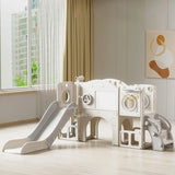 Children's playset with slide and climbing structure in a room with large window and abstract art on wall.