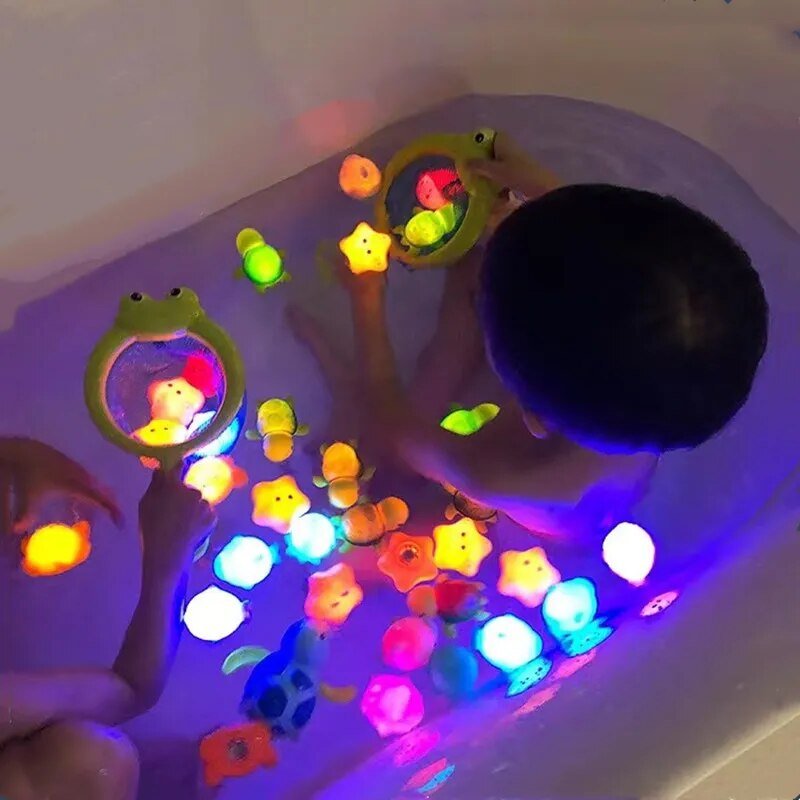Child playing with colorful light-up toys in a bathtub