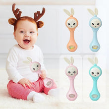 Baby with toy rattle and colorful rattles