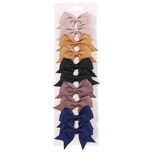 Colourful bow hair clips for girls daily hair accessories, ponytails and half-up styles.