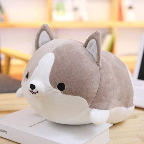 Plush toy dog-shaped pillow on a book 