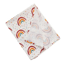 Super Soft Cotton Gauze Muslin Swaddle and Bath Towel, folded fabric with rainbow pattern, for newborn swaddling, bath time, and stroller outings.