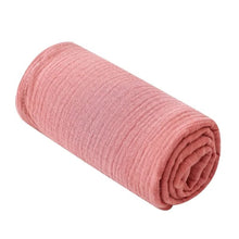 Super Soft Cotton Gauze Muslin Swaddle and Bath Towel, rolled pink fabric, for newborn swaddling, bath time, and stroller outings.
