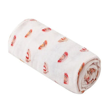Super Soft Cotton Gauze Muslin Swaddle and Bath Towel, rolled-up fabric with a pattern, for newborn swaddling, bath time, and stroller outings.