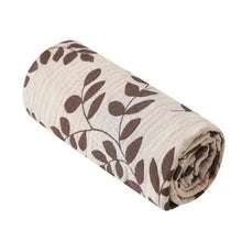 Super Soft Cotton Gauze Muslin Swaddle and Bath Towel, rolled-up fabric with brown leaf pattern, for newborn swaddling, bath time, and stroller outings.