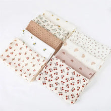 Super Soft Cotton Gauze Muslin Swaddle and Bath Towel, set of six fabric swatches with various patterns, for newborn swaddling, bath time, and stroller outings.