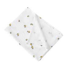 Super Soft Cotton Gauze Muslin Swaddle and Bath Towel, white fabric with small green and yellow patterns, for newborn swaddling, bath time, and stroller outings.