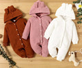 Three baby rompers in brown, pink, and white.