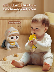 Baby holding a yellow duck toy next to a crawling baby doll in a duck hood