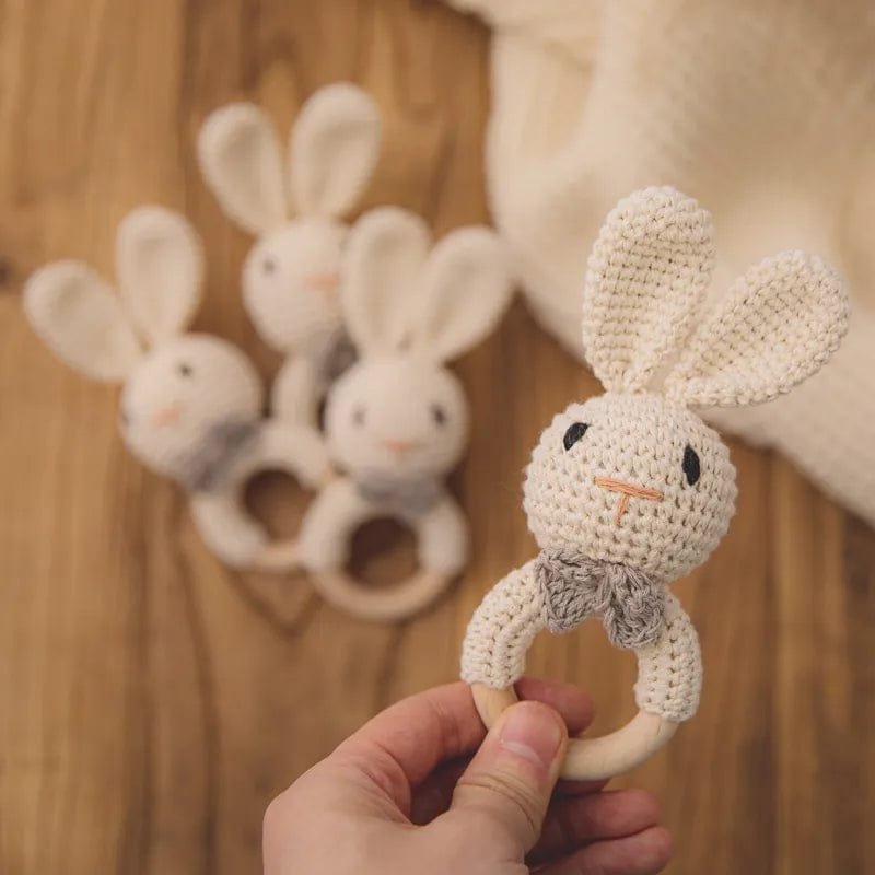 Crochet baby rattle and teether ring collection in multiple colours, gentle toys for grasping practice and teething relief.