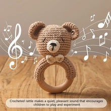Hand-knit crochet bear rattle teether bracelet for babies to hold, shake, and chew during teething stages.