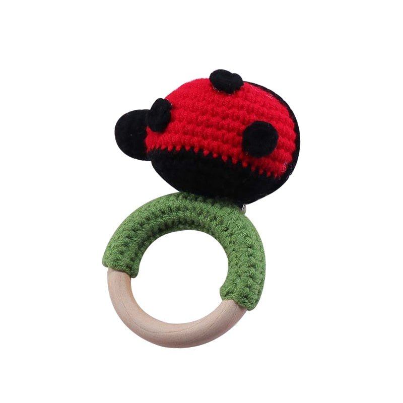 Crochet Ladybug Rattle and Teether plush toy with wooden ring detail for car seat toy and travel entertainment.