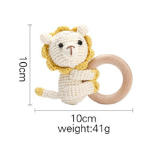 Crochet Lion Rattle and Teether plush toy with wooden ring detail for nursery decor and crib toy display.
