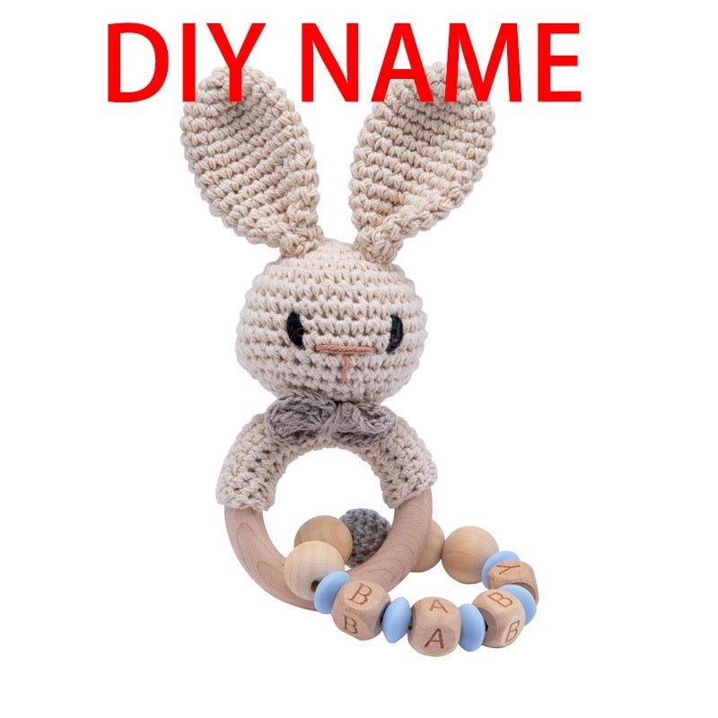 Crochet Off-White Bunny Rattle and Teether plush toy with wooden beads for car seat toy and travel entertainment.