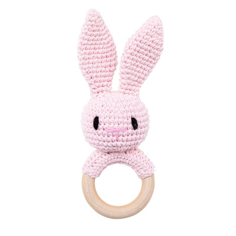 Crochet Pink Bunny Rattle and Teether plush toy with wooden ring for grasping practice and early motor skill development.