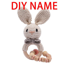 Crochet Rabbit Rattle and Teether plush toy with wooden ring detail for nursery decor and crib toy display.