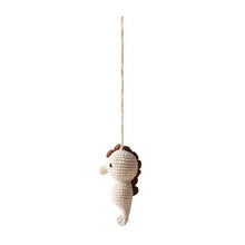 Soft yarn detail of the crochet seahorse pendant, a gentle hanging toy for baby play gyms and cot mobiles.