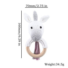 Crochet Unicorn Rattle and Teether plush toy with wooden ring for grasping practice and early motor skill development.