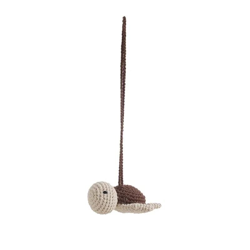 Crochet whale pendant hanging from the wooden baby gym, a rattle toy for newborn play and pram entertainment.