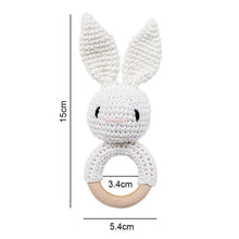 Crochet White Bunny Rattle and Teether plush toy with wooden ring for car seat toy and travel entertainment.
