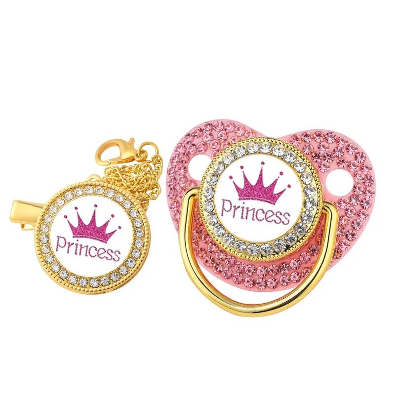 Luxury Crown Pacifier & Clip Set, pink and gold pacifier with Princess and crown design on a white background, for stroller clip attachment and outings.