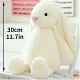 White plush bunny toy with measurement text 