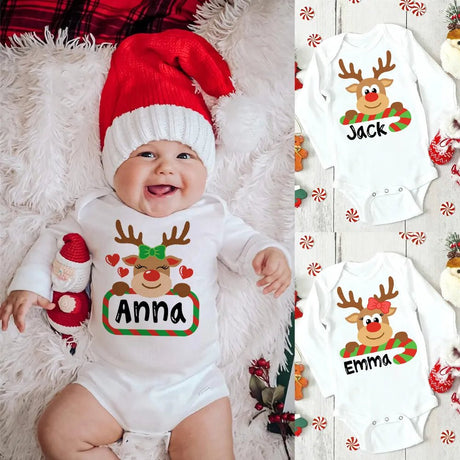 Baby wearing a Christmas-themed onesie with reindeer design and name 'Anna'.