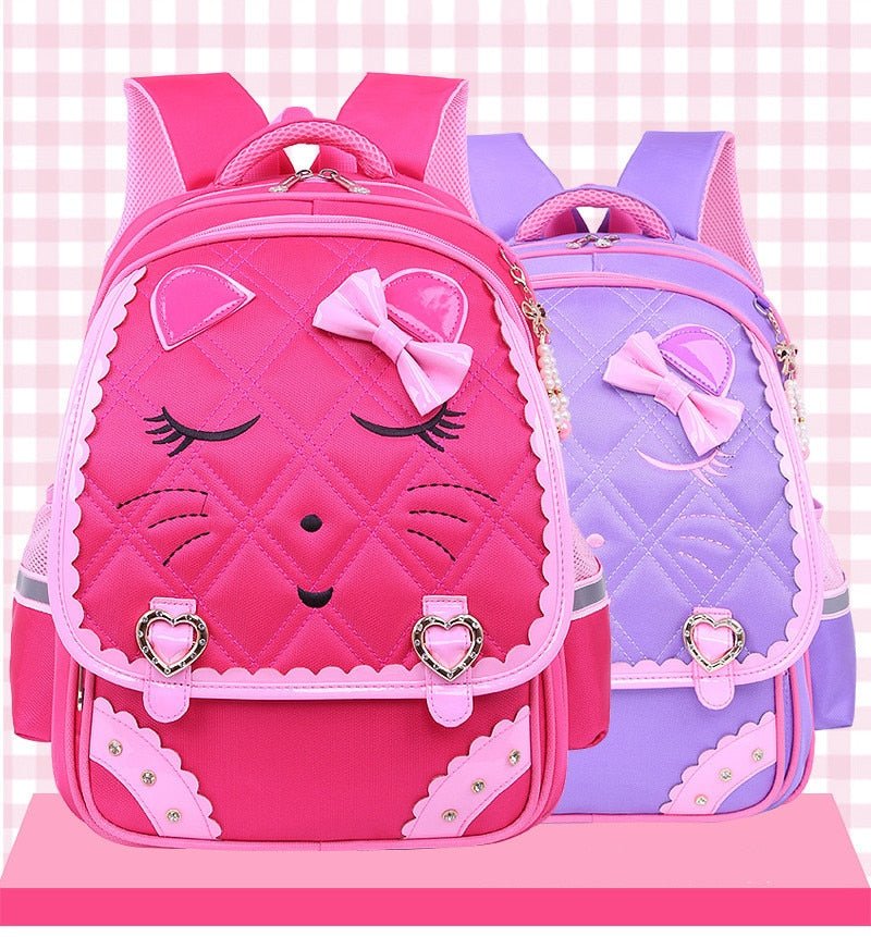 Two pink and purple backpacks with cat face designs.