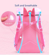 Pink backpack with blue straps on a pink background, highlighting soft and breathable material.