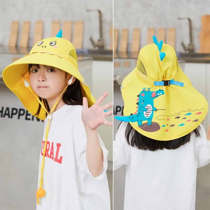 Child wearing a yellow dinosaur-themed sun hat indoors.