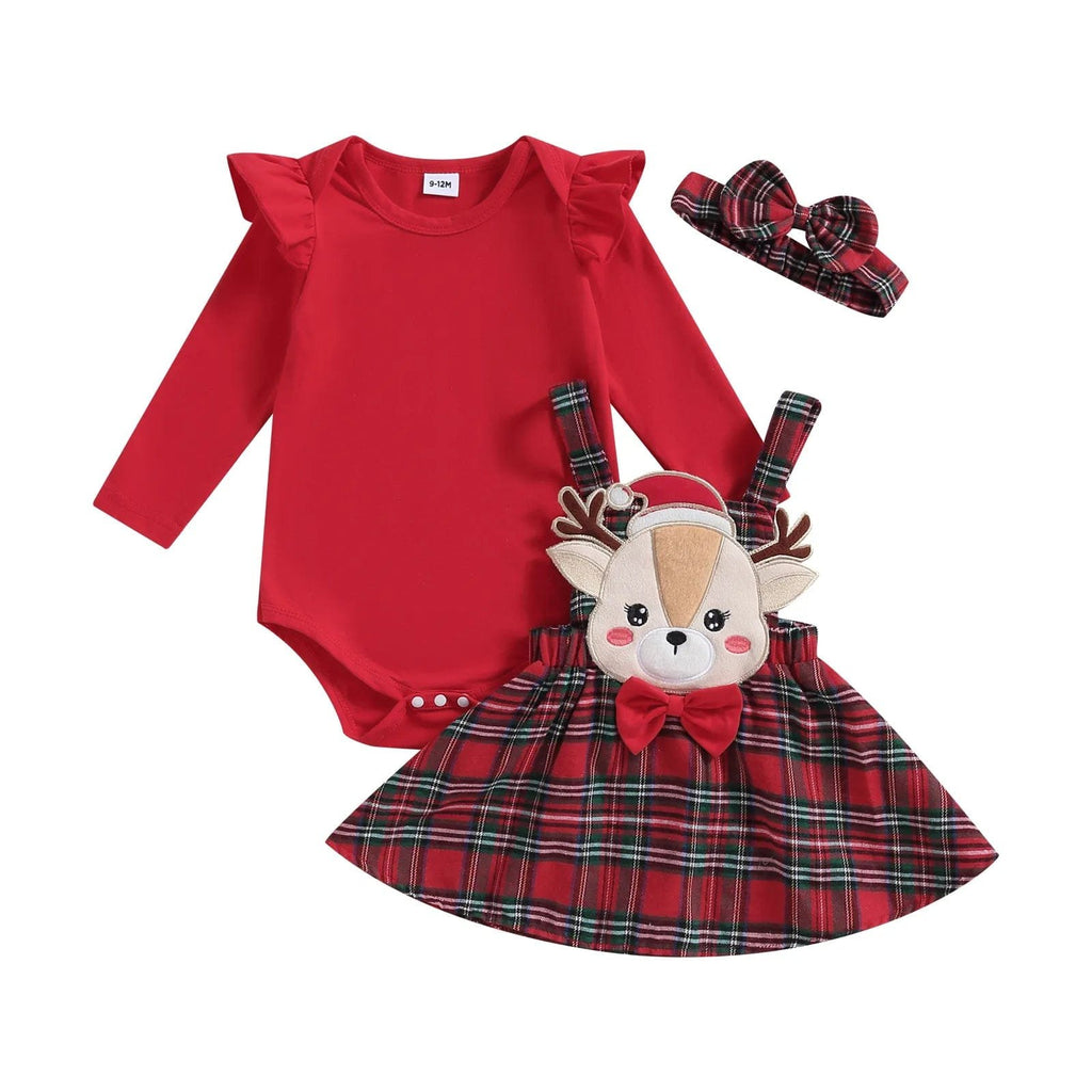 Red baby outfit with plaid skirt, reindeer plush toy, and headband on a white background