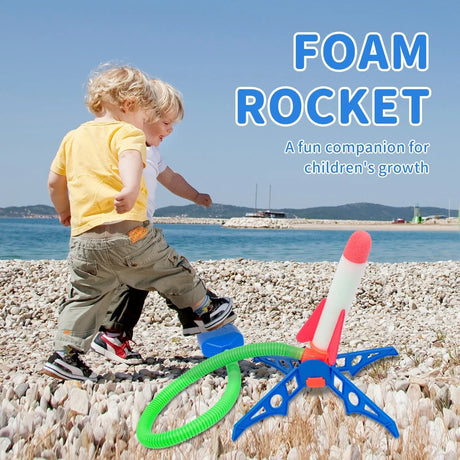 Two children playing with a foam rocket on a pebbly beach.