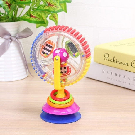 Colorful toy with Ferris wheel and rings on a wooden surface