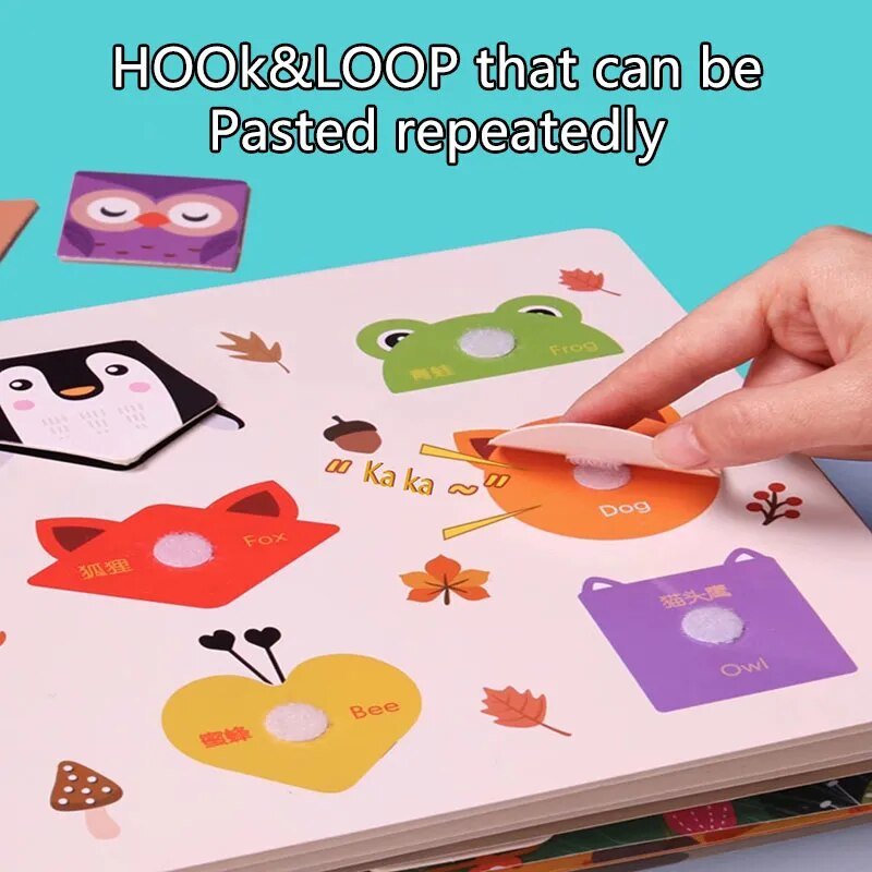 Colorful educational book with animal-themed stickers being pasted by a hand on a blue background.