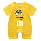 Yellow baby romper with a smiley face and 'm' logo