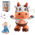 Dancing cow toy with red light-up horns, music notes and its gift box beside a laughing baby