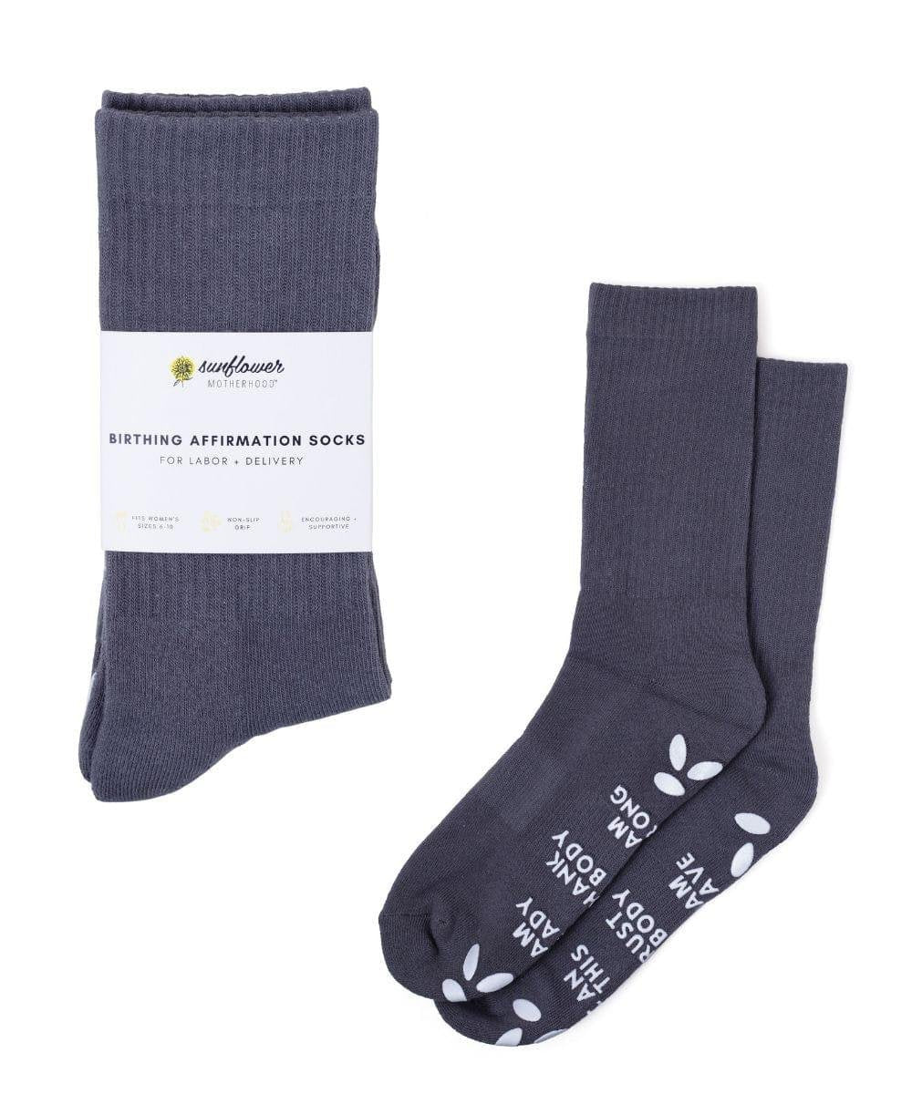 Dark gray empowering birth affirmation hospital socks with white lettering for delivery day.