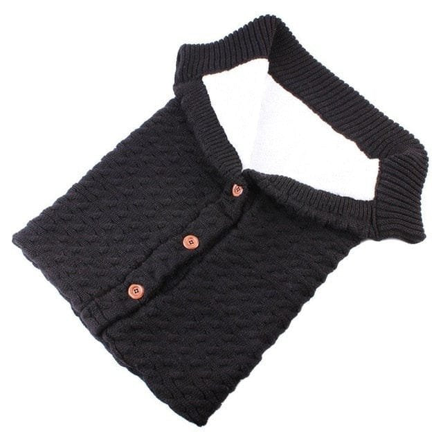 Dark grey newborn sleeping bag button detail for quick dressing and secure fastening at bedtime.