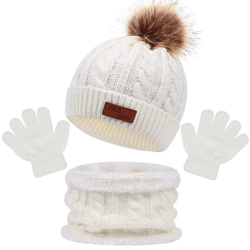 White knit beanie with pom-pom, gloves, and neck warmer set on a white background