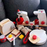 Wooden toy kitchen set with various appliances and food items on a dark surface.