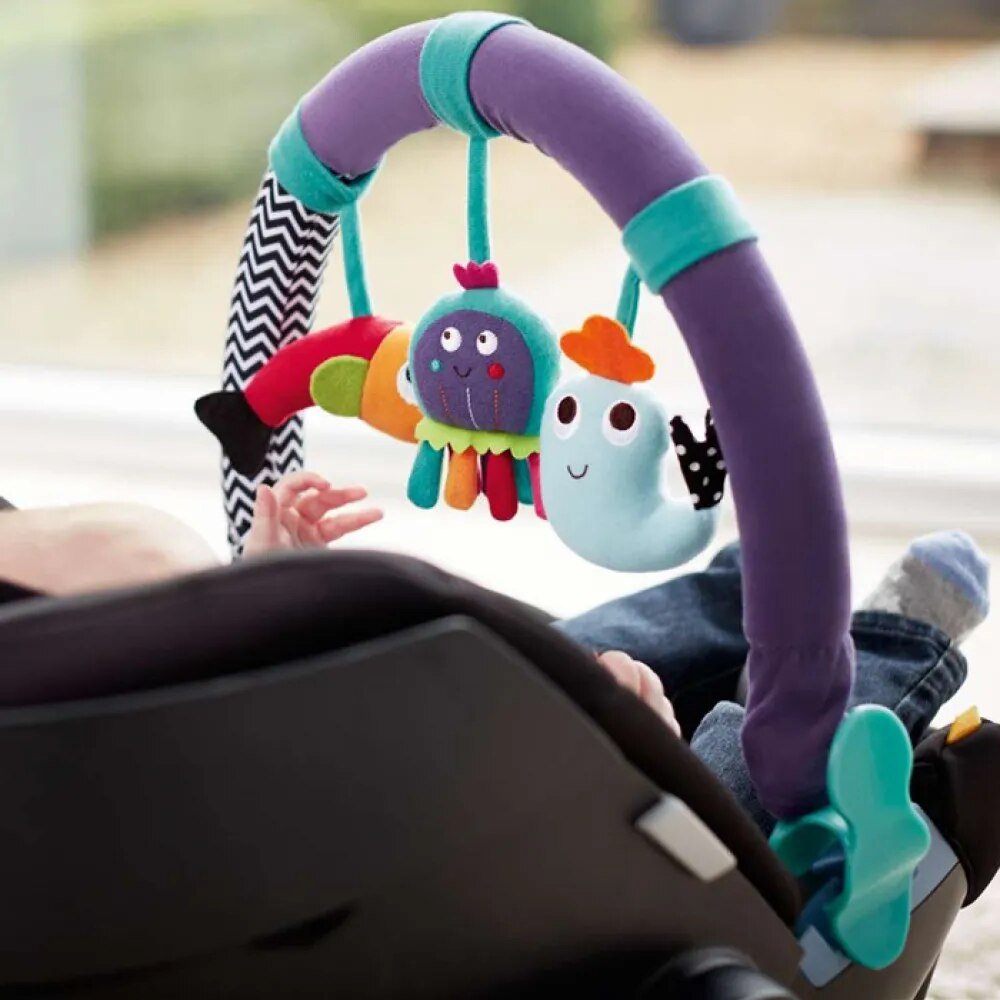 Colorful baby car seat toy with hanging characters in a stroller.