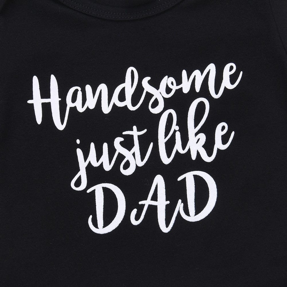 Black t-shirt with white text 'Handsome just like DAD' on a plain background