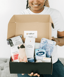 Person holding a box with various products including a Colace container.