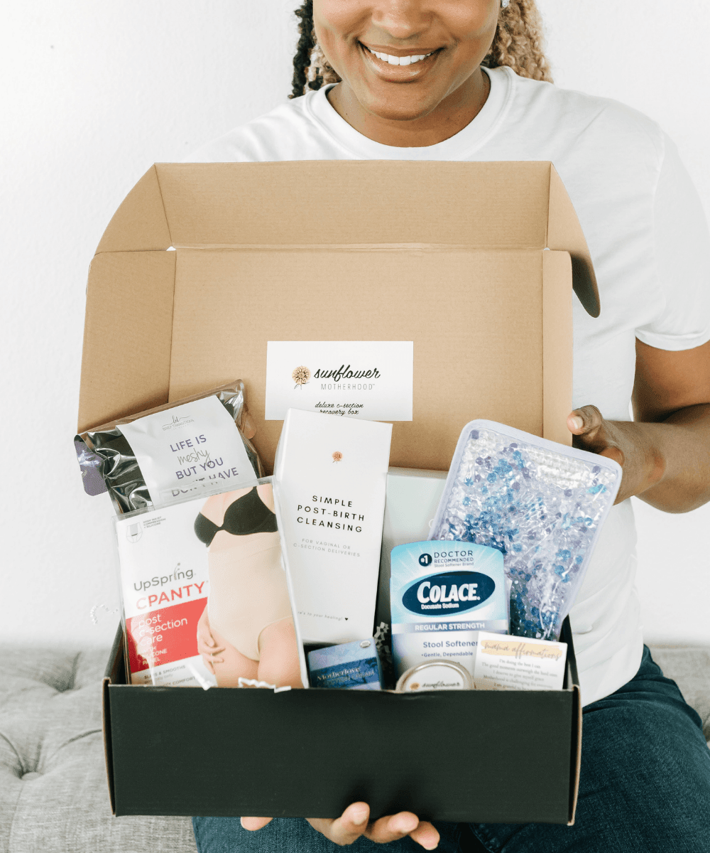 Person holding a box with various products including a Colace container.