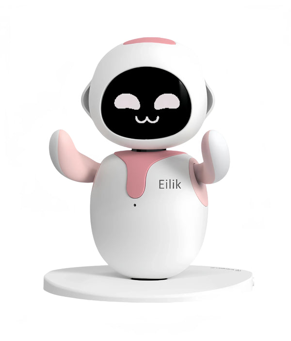 Pink and white desktop robot pet with a black screen face and smiling eyes, arms raised, on a round base